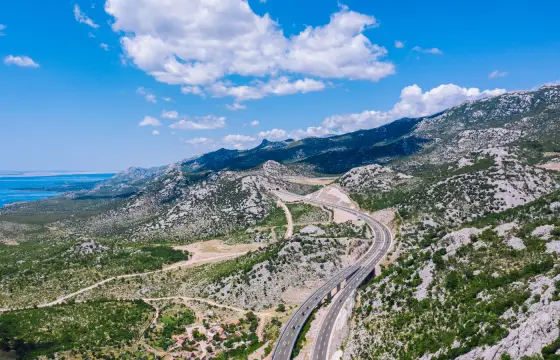 The A1 running through white karst with the Adriatic beyond
