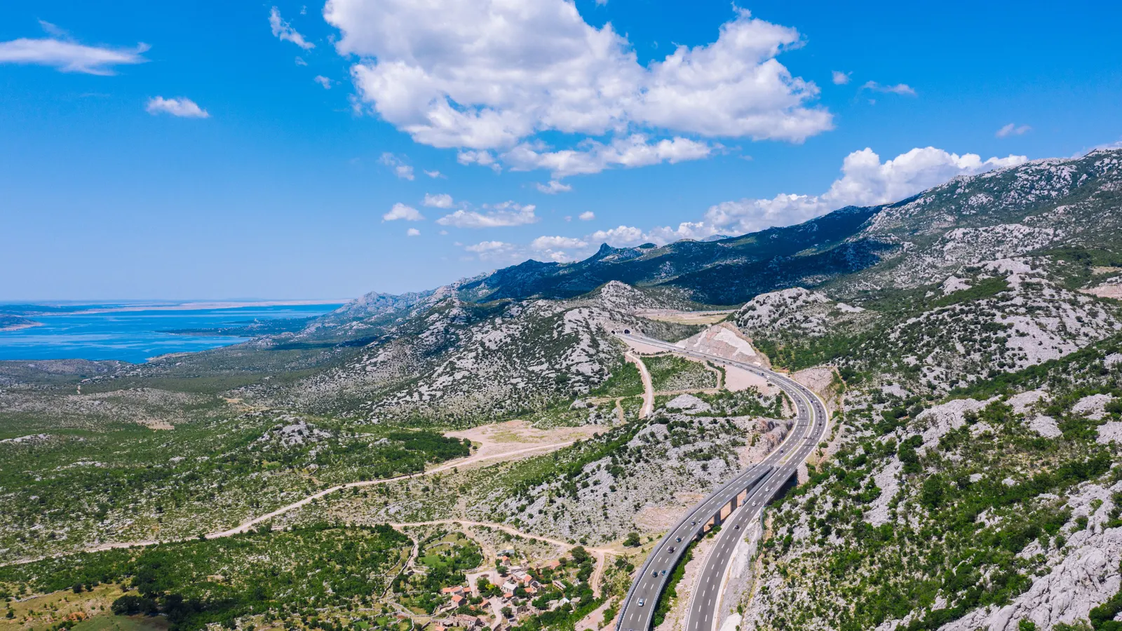 The A1 running through white karst with the Adriatic beyond