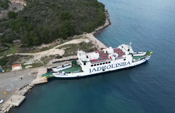 A car ferry berthed in a rocky cove on the Dalmatian coast