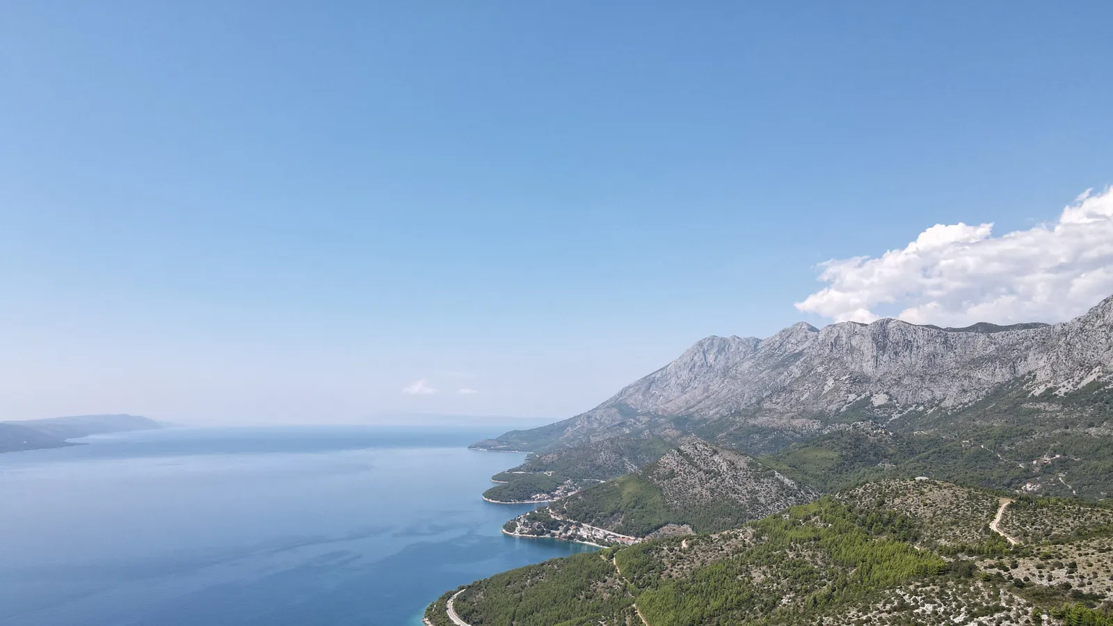 The coastline from the air with the road running along the slope