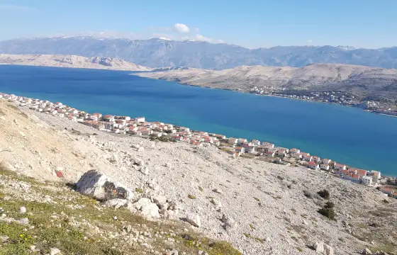 The bare karst of Pag with the Velebit behind