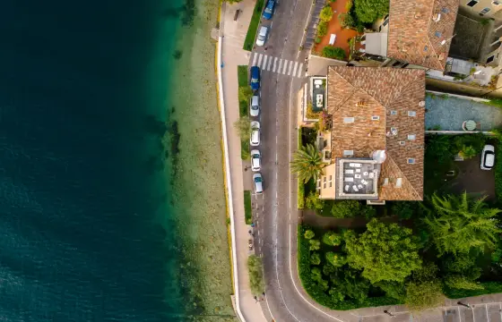 Cars parked along a coastal road above the water