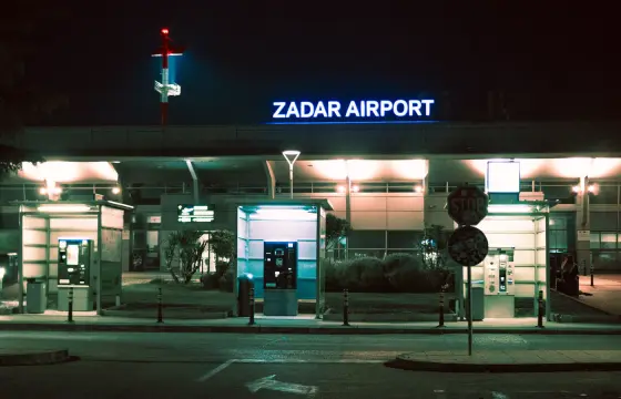 The lit entrance of Zadar Airport in the evening